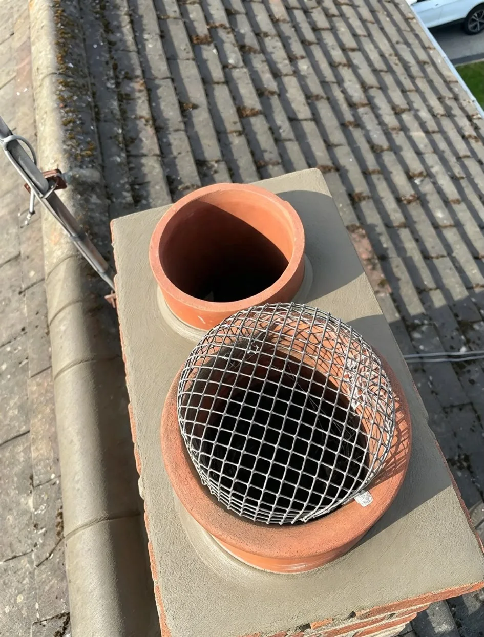Rebuilt chimney with new flaunching, chimney pots and bird guard cowl